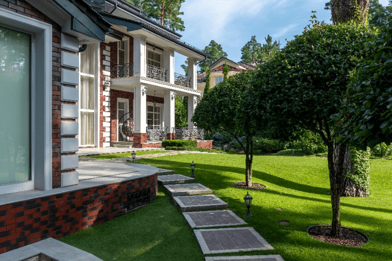 Lawn Care for Beginners; 10 Essential Basics 2 Lawn care for front yard with stone path and trees